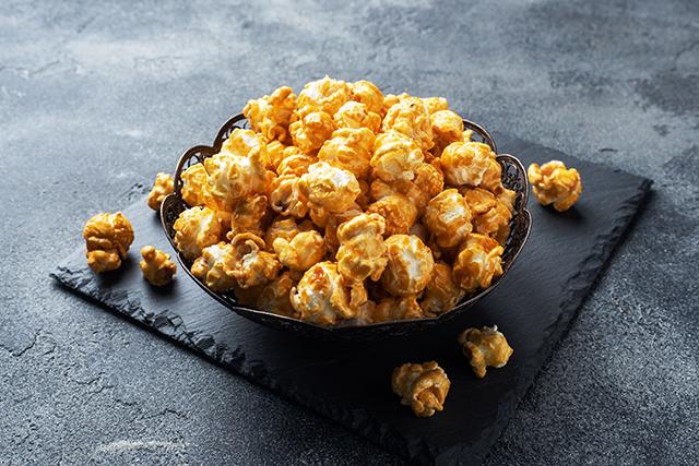 A bowl filled with caramel popcorn.