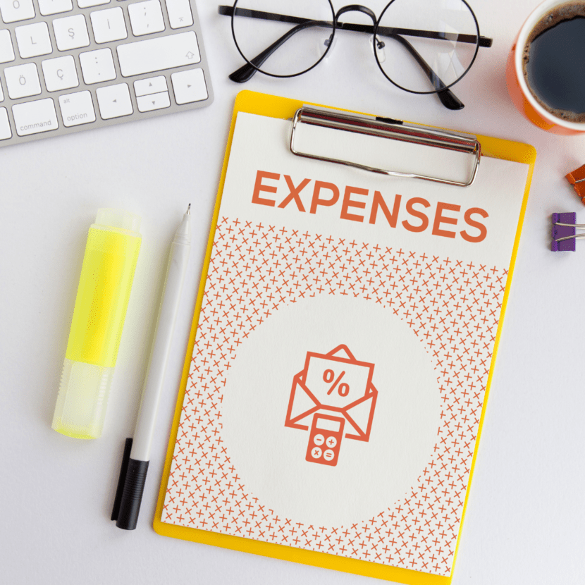 A desk with an expenses graphic.