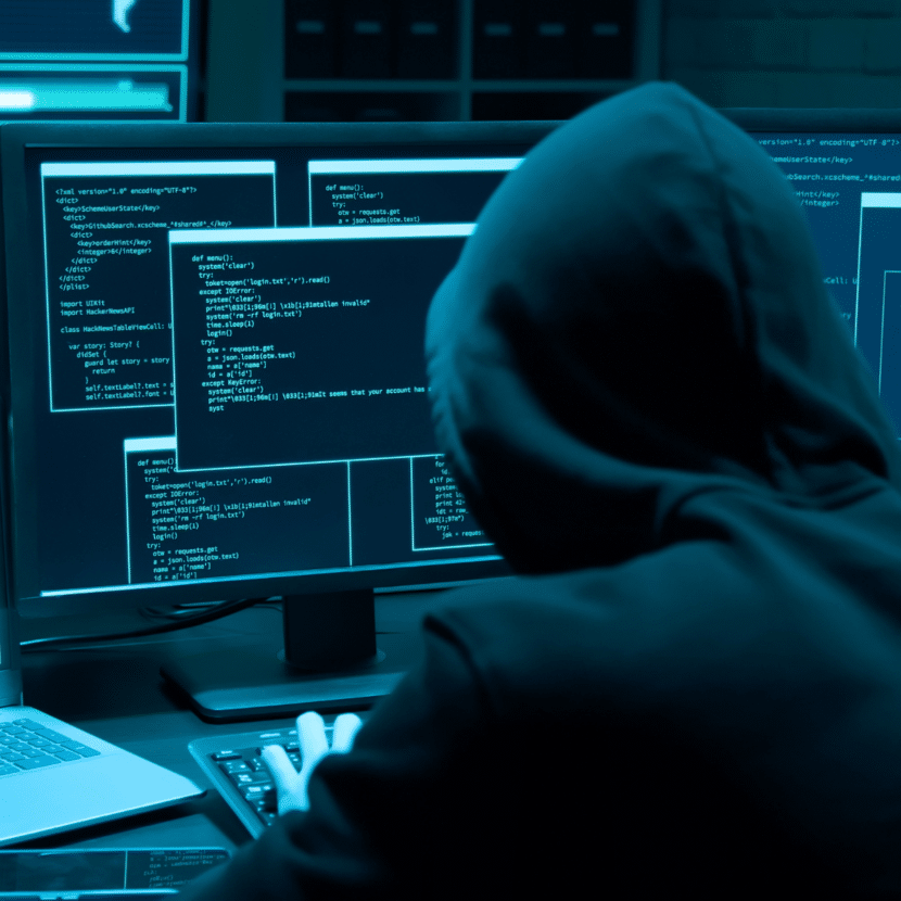 Image of person committing online financial crimes by hacking.