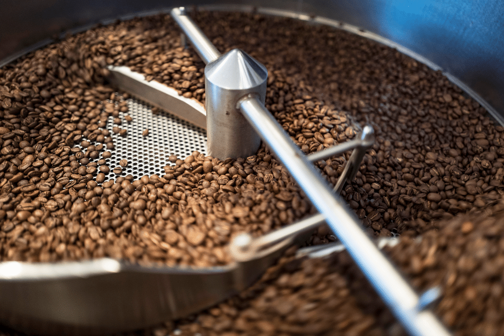 A premium blend of coffee beans being roasted in a machine. 