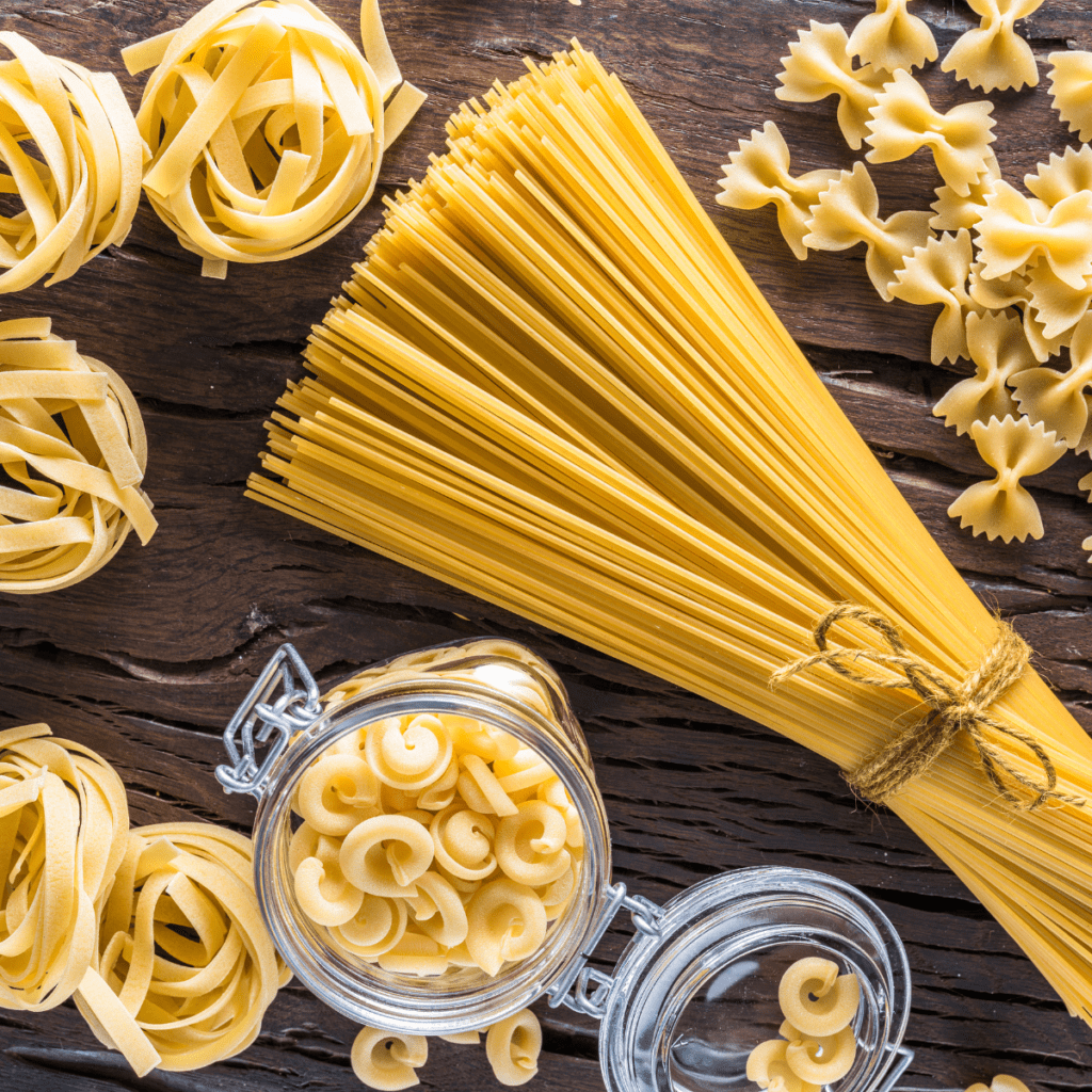 Pasta in various shapes including spaghetti, fettuccine, and farfalle.