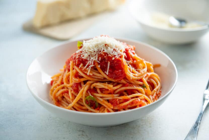Bowl of spaghetti made with homemade marinara sauce and parmesan cheese